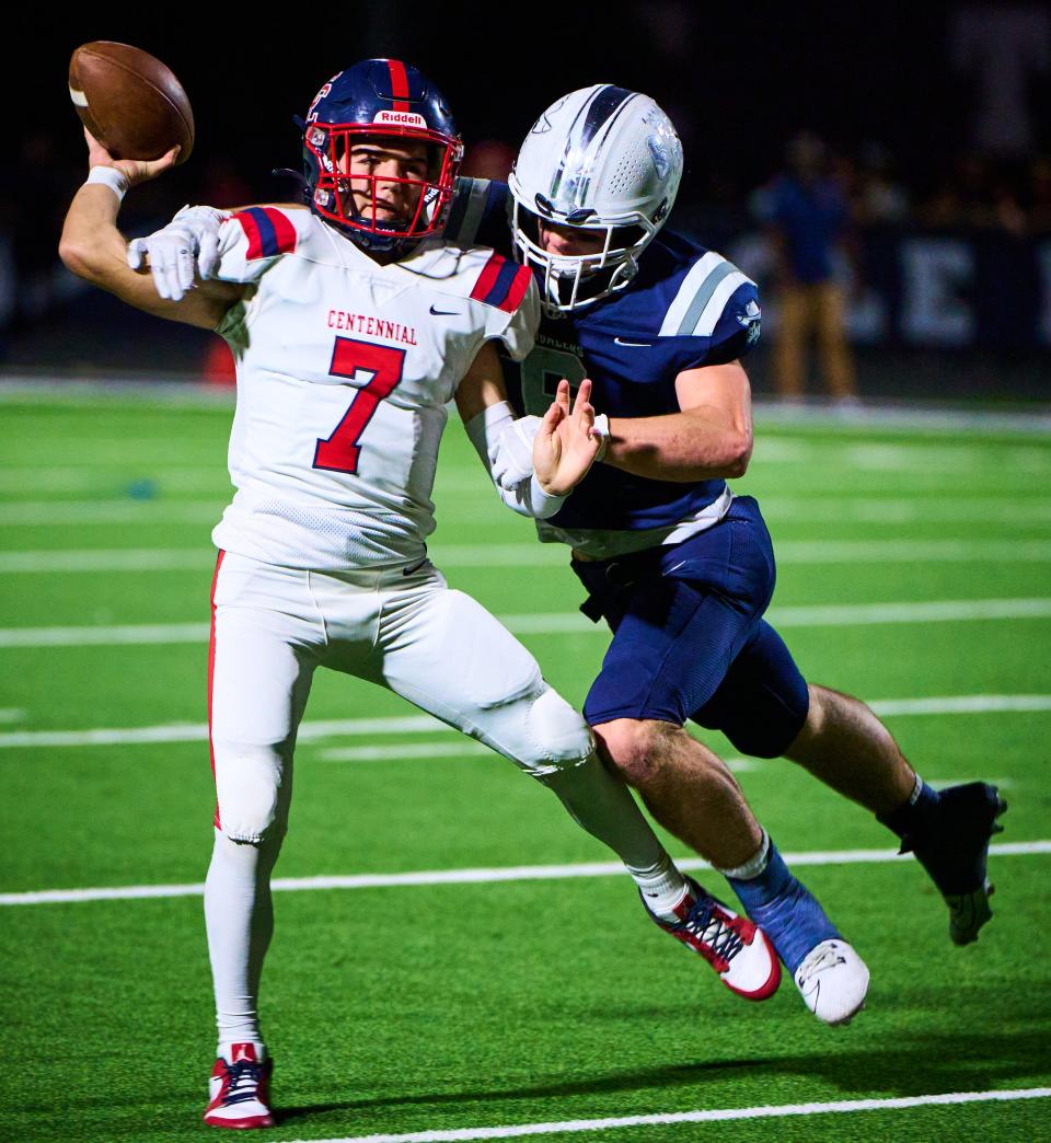 To avoid being sacked by Pinnacle Pioneers linebacker Dean Vincent (6), Centennial Coyotes quarterback Kainan Manna (7) attempts a pass at Pinnacle High School in Phoenix on Oct. 27, 2023.