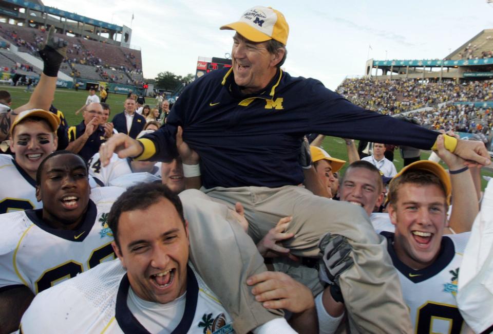 Michigan football player Will Heininger, right wearing a hat is all smiles as he and teammates carry off their head coach, Lloyd Carr, after their Citrus Bowl game against the University of Florida at the Capital One Bowl in Orlando, Florida on January 1, 2008. Michigan won the bowl game 41-35. Heininger, was dealing with pressure and bouts of depression during this time and now teaches around the country to middle and high schoolers the warning signs and what to do about them.