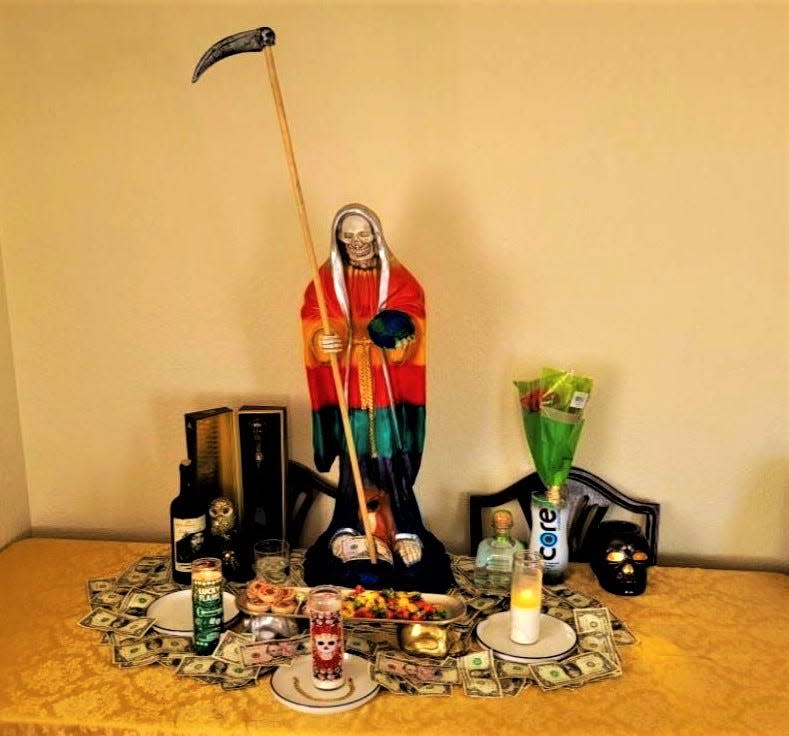 A Santa Muerte altar typically has offerings of fruit, cash, candy and liquor. This altar was found by federal agents at a suspected migrant stash house in Sparks in eastern El Paso County on Sept. 5, 2023.