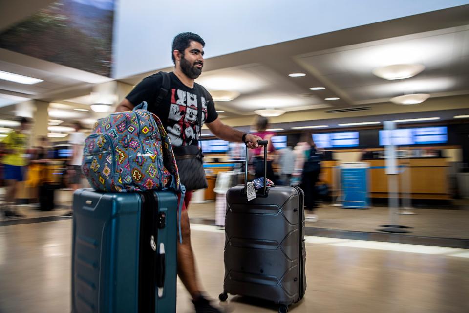 Hassan Alnasser walks through the Asheville Airport July 14, 2023, to check in to his flight back to Phoenix after vacationing in Gatlinburg and Pigeon Forge with family visiting from Saudi Arabia.