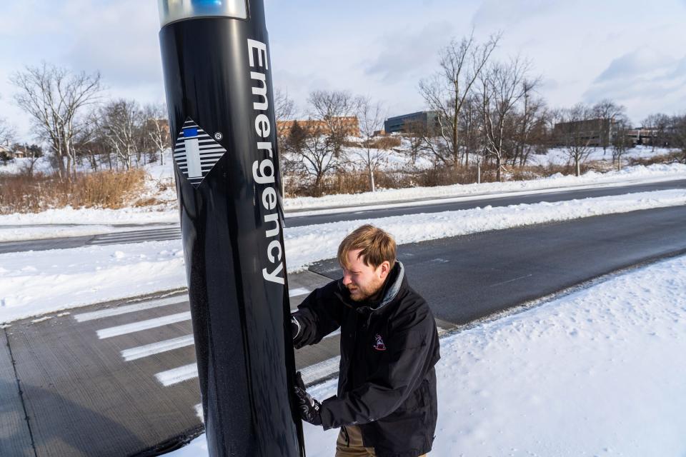 Oakland University Police Department IT manager Kyle Romstad shows how they tend to emergency phones around campus while resetting a phone in a parking lot following a recent firmware update at the campus in Auburn Hills on Tuesday, Jan. 16, 2024.