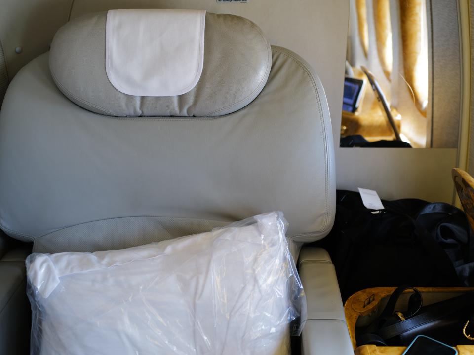 First-class airline seat with pillows on it