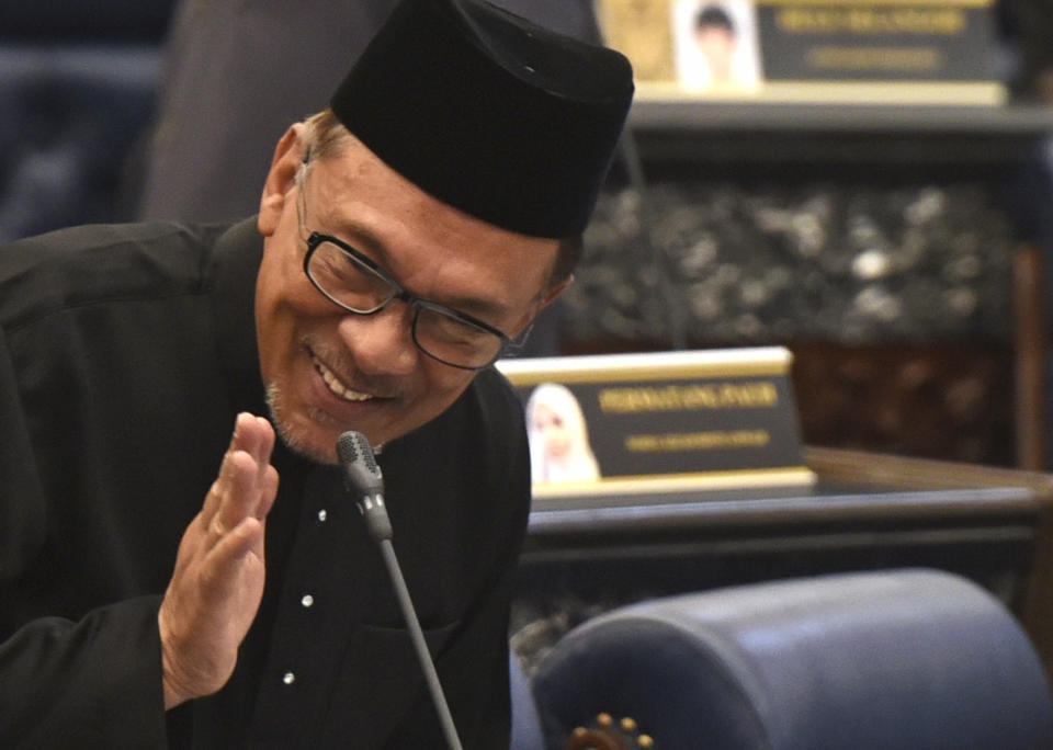 Malaysian politician Anwar Ibrahim greets after his swearing-in as a lawmaker at the parliament in Kuala Lumpur, Monday, Oct. 15, 2018. Charismatic Malaysian politician Anwar won a by-election for a parliamentary seat with a landslide victory on Saturday in a grand political comeback to help him prepare for his eventual takeover from Prime Minister Mahathir Mohamad. (AP Photo/Yam G-Jun)