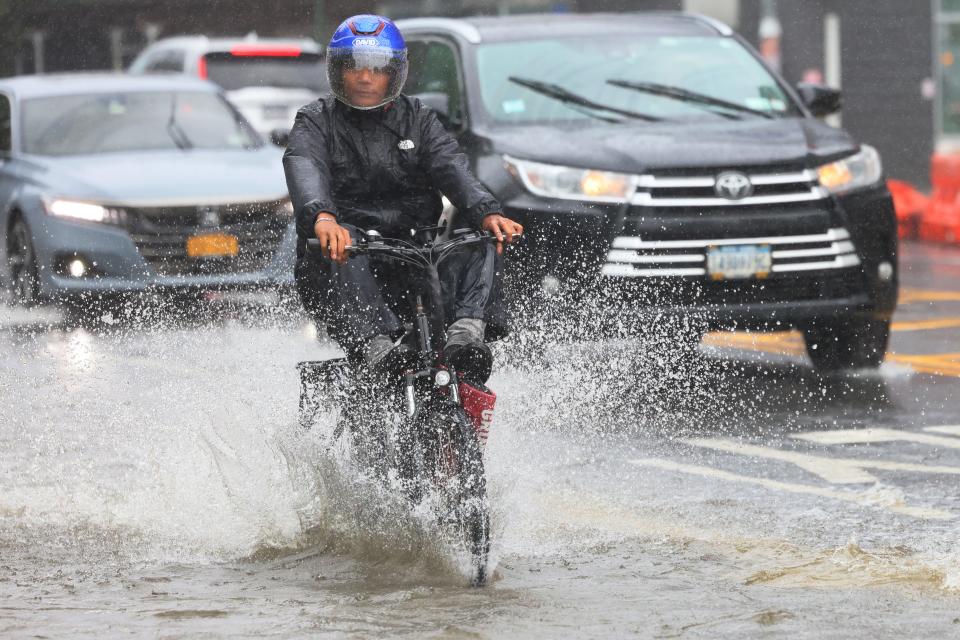 A rides their E-Bike along a flooded Coney Island Avenue amid a coastal storm on September 29, 2023 in the Flatbush neighborhood of Brooklyn borough New York City. Flash flooding is expected in the counties of Nassau, Queens and Kings, which includes Brooklyn, according to the state’s National Weather Service office as remnants of Tropical Storm Ophelia reaches the Northeast. Gov. Kathy Hochul has declared a state of emergency for the NYC area.