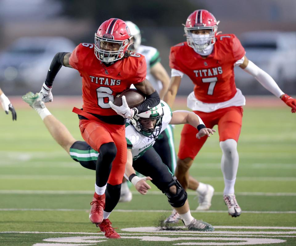 Carl Albert's Trystan Haynes gets by Bishop McGuinness' Jace Weeks on the way to a touchdown during the high school football game between Carl Albert and Bishop McGuinness at Carl Albert High School in Midwest City, Okla., Friday, Oct., 13, 2023.