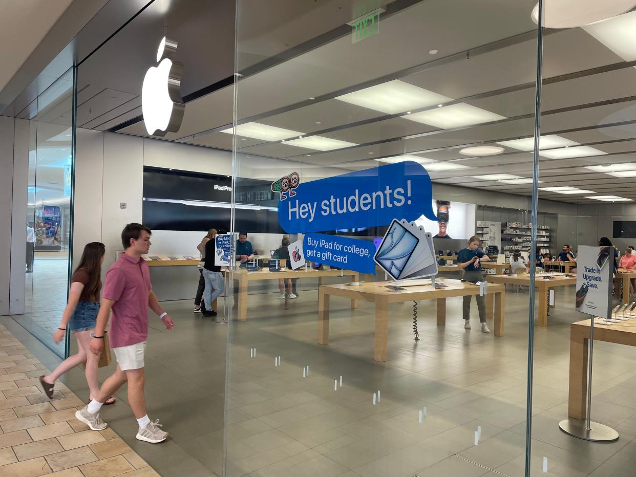 Shoppers walk into the Apple Store at the Summit Mall in Fairlawn.