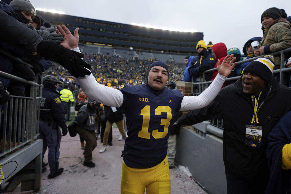 Michigan place kicker Jake Moody (13) celebrates after an NCAA college football game against Illinois in Ann Arbor, Mich., Saturday, Nov. 19, 2022. Michigan won 19-17. (AP Photo/Paul Sancya)