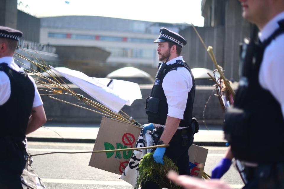 Police dismantle the camps at the Extinction Rebellion demonstration on Waterloo Bridge (PA)