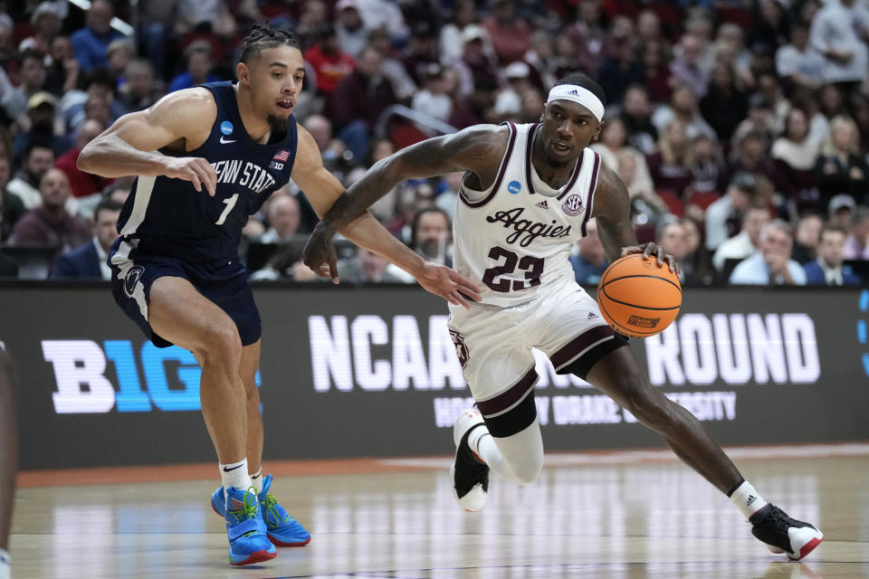 Texas A&M guard Tyrece Radford (23) drives past Penn State guard Seth Lundy (1) in the first half of a first-round college basketball game in the NCAA Tournament, Thursday, March 16, 2023, in Des Moines, Iowa. (AP Photo/Charlie Neibergall)