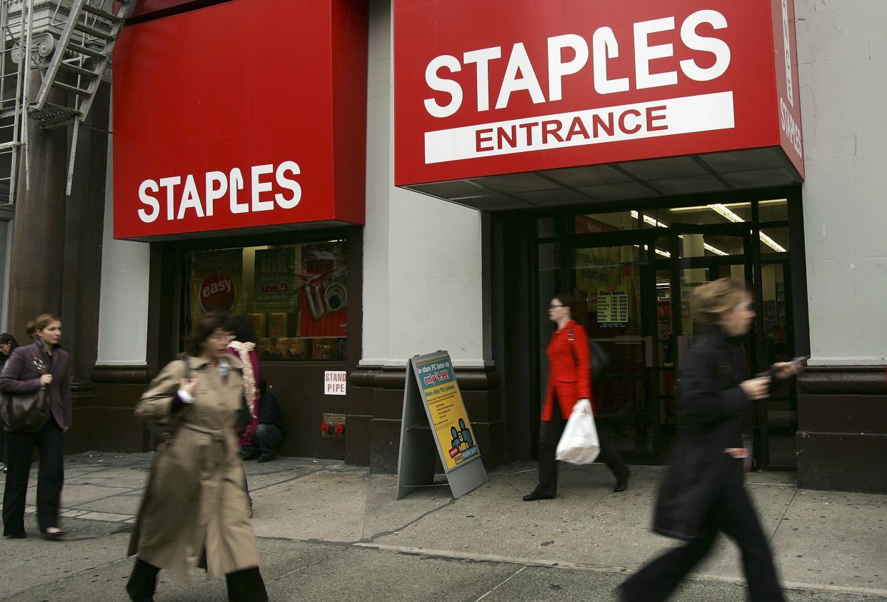Pedestrians pass a Staples store November 14, 2006 in New York City.