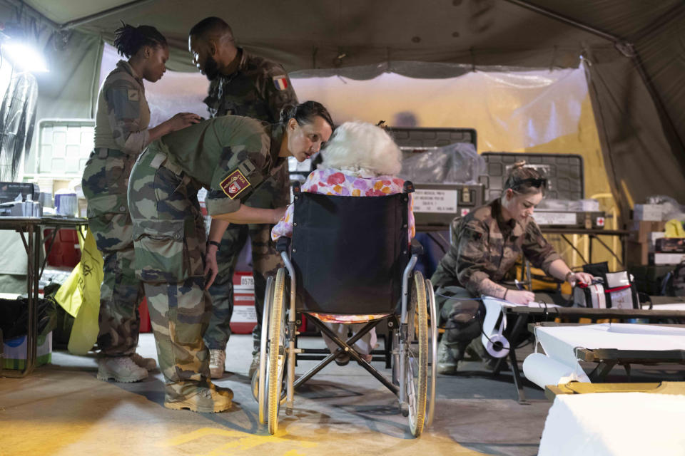 This photo provided by the French Army shows military nurses taking care of French citizen after arriving in Djibouti, Sunday, April 23, 2023. Two French military planes evacuating about 200 people from multiple countries left Khartoum on Sunday for Djibouti as France urged all parties to stop fighting and return to political dialogue, in a statement by the Foreign Ministry and Defense Ministry. (Etat Major des Armies via AP)