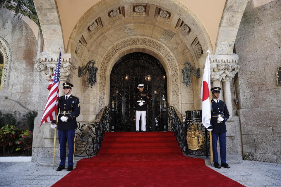 FILE - In this April 17, 2018, file phot, military members get into place before President Donald Trump welcomes Japanese Prime Minister Shinzo Abe to Trump's private Mar-a-Lago in Palm Beach, Fla. rump is making his return to Florida, kicking off the Palm Beach social season at his “winter White House.” All presidents have had their favorite refuges from Washington. But none has drawn the fascination or raised the ethical issues of Mar-a-Lago, where Trump spends his days mixing work, business and play in the company of dues-paying members and staff are on high alert for those seeking influence. (AP Photo/Pablo Martinez Monsivais, file)