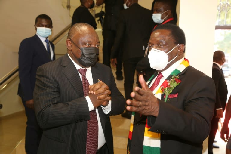 South African President Cyril Ramaphosa, left, speaks with Zimbabwean President Emmerson Mnangagwa during the memorial service