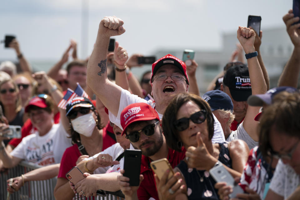 Supporters of President Donald Trump cheer as he arrives at Wilmington International Airport, Wednesday, Sept. 2, 2020, in Wilmington, N.C. (AP Photo/Evan Vucci)