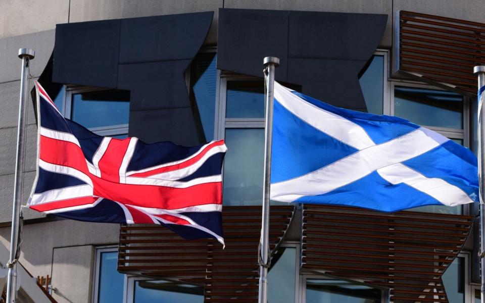 The Union Flag and the Scottish saltire fly outside the Scottish Parliament building in Edinburgh - Ken Jack/Corbis News