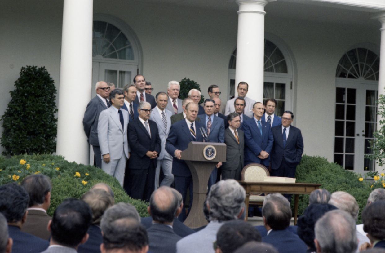 President Gerald R. Ford and Members of Congress at the Signing Ceremony for the Employee Retirement Income Security Act of 1974 in the White House Rose Garden