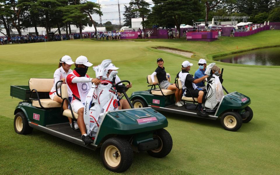 Mone Inami of Japan and Lydia Ko of New Zealand head to the 18th hole to play a silver medal play-off. - REUTERS/Murad Sezer