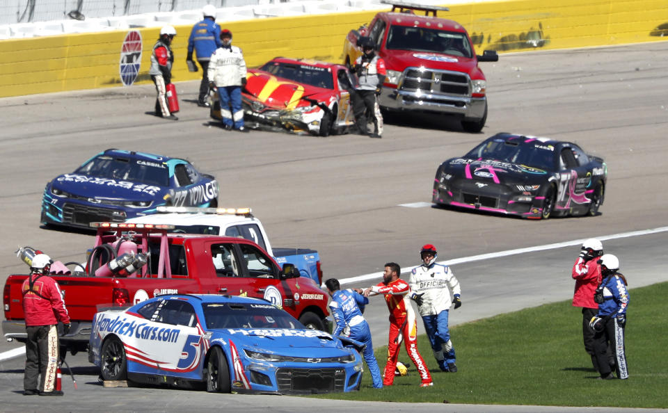 Bubba Wallace, center right, shoves Kyle Larson (5) after they crashed during a NASCAR Cup Series auto race at Las Vegas Motor Speedway in Las Vegas, Sunday, Oct. 16, 2022. (Steve Marcus/Las Vegas Sun via AP)