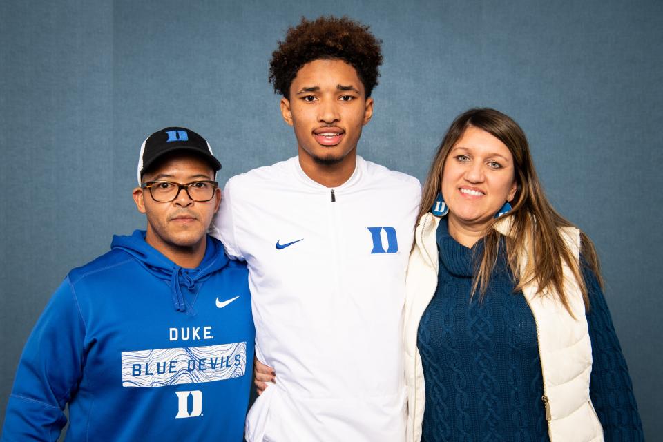 Mt. Juliet's Malik Bowen, center, poses for a portrait with his parents Chris Sims and Michelle Sims after appearing on the Bootleg Signing Day show at The Tennessean newsroom in Nashville, Tenn., Wednesday, Dec. 18, 2019.