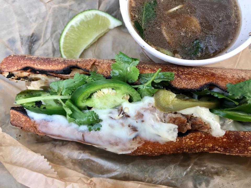 The Pho-rench Dip sandwich from Thum is beef brisket on baguette with melted cheese, cilantro and jalapeno, with beefy pho broth for dipping.