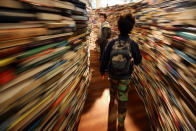 Children run in the 'aMAZEme' labyrinth made from books at The Southbank Centre on July 31, 2012 in London, England. (Photo by Peter Macdiarmid/Getty Images)