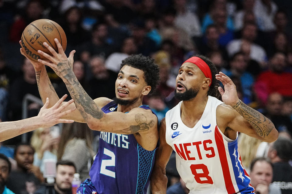 Charlotte Hornets guard James Bouknight (2) drives past Brooklyn Nets guard Patty Mills (8) during the first half of an NBA basketball game, Saturday, Nov. 5, 2022, in Charlotte, N.C. (AP Photo/Rusty Jones)