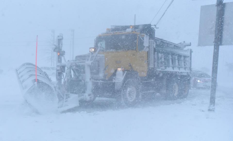 Follow the leader as a plow guides cars during white-out conditions Saturday morning around the Airport Rotary in Hyannis as the blizzard raged through Hyannis.