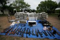 FILE PHOTO: Packs of marijuana, weapons and other scales are displayed after an operation against drug hitmen by Mexican soldiers at a ranch near the municipality of Sabinas Hidalgo