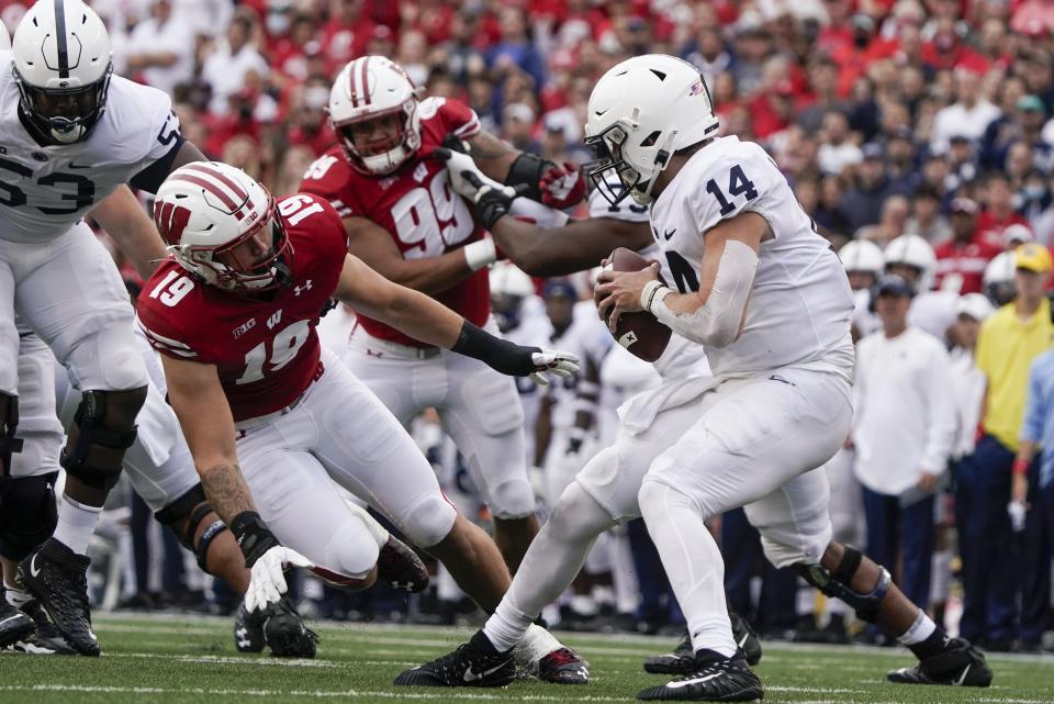 Penn State's Sean Clifford tries to get away from Wisconsin's Nick Herbig during the first half of an NCAA college football game Saturday, Sept. 4, 2021, in Madison, Wis. (AP Photo/Morry Gash)