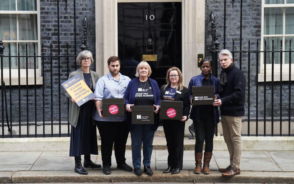 A petition signed by 100,000 members of the public, nursing staff and patients is delivered to 10 Downing Street in London calling on Prime Minister Rishi Sunak to pay nursing staff fairly - James Manning/PA