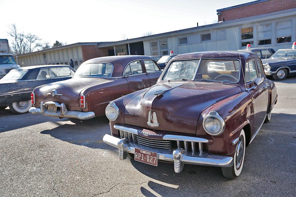 Vintage vehicles are parked at the closed Foster School in Braintree for filming of "Boston Strangler" on Thursday, Jan. 27, 2022.