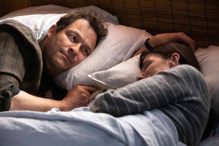 Dominic West looks at Maura Tierney, who's in bed sleeping
