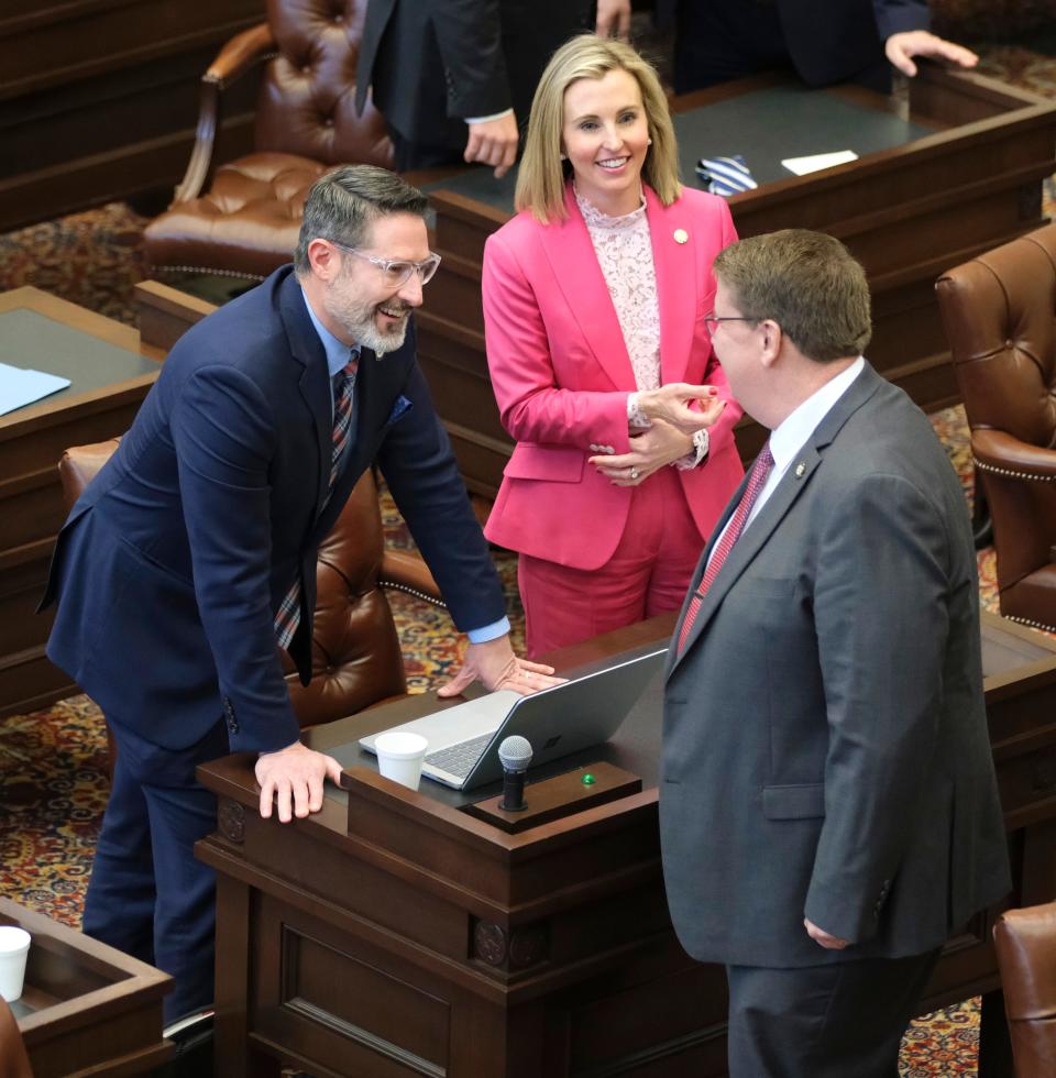 Sen. Greg McCourtney, right, talks with Sens. Dusty Deevers and Kristen Thompson during a session Monday at the state Capitol.