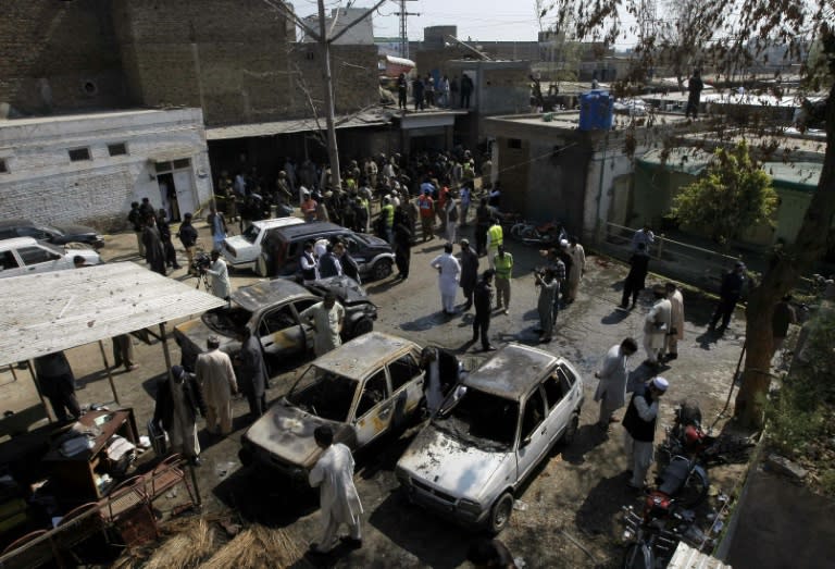 Pakistani security officials inspect the site of a suicide bombing in Shabqadar on March 7, 2016