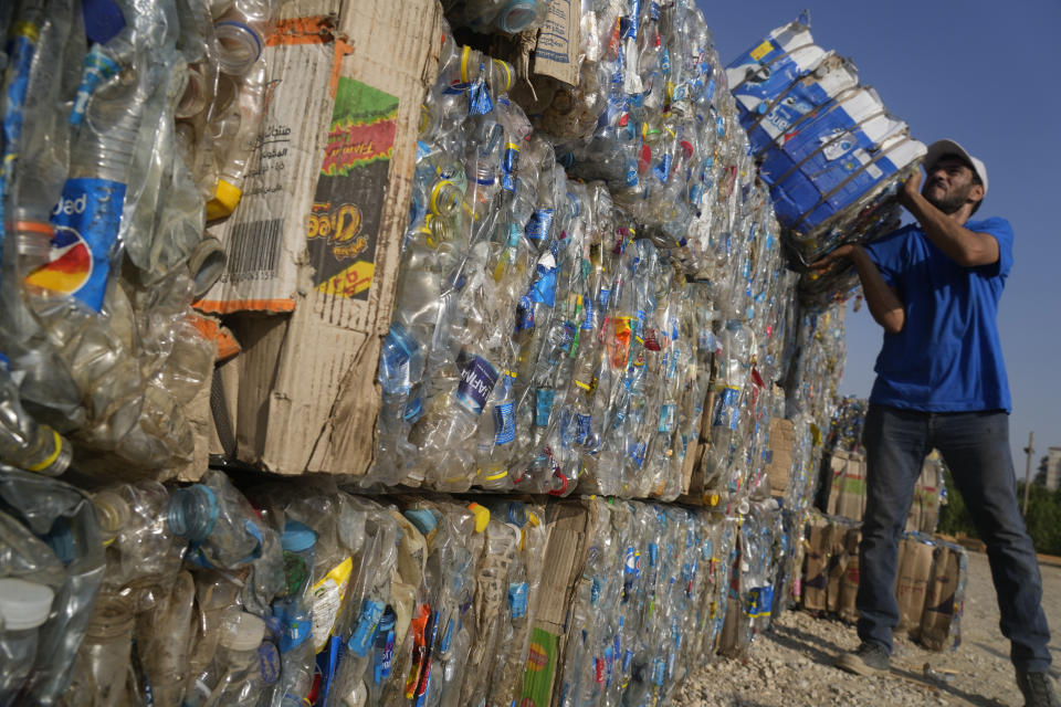 FILE - "Verynile" initiative worker carries compressed plastic bottles which were collected by volunteers and fishermen from the Nile to build a Plastic Pyramid ahead of World Cleanup Day in Cairo, Egypt, Thursday, Sept. 15, 2022 The pyramid aiming to raise awareness on plastic pollution in the Nile. Negotiators from around the world gather at UNESCO in Paris on Monday, May 29, 2023, for a second round of talks aiming toward a global treaty on fighting plastic pollution in 2024. (AP Photo/Amr Nabil,File)