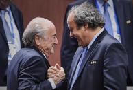 FIFA President Sepp Blatter (Foreground-L) shakes hands with UEFA president Michel Platini after being re-elected following a vote to decide on the FIFA presidency in Zurich on May 29, 2015. Sepp Blatter won the FIFA presidency for a fifth time after his challenger Prince Ali bin al Hussein withdrew just before a scheduled second round. AFP PHOTO / MICHAEL BUHOLZER / AFP / MICHAEL BUHOLZER (Photo credit should read MICHAEL BUHOLZER/AFP via Getty Images)