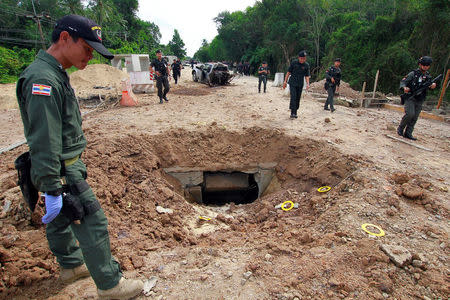 Military personnel search the site of a roadside bomb blast in the southern province of Pattani, Thailand, September 22, 2017. REUTERS/Surapan Boonthanom