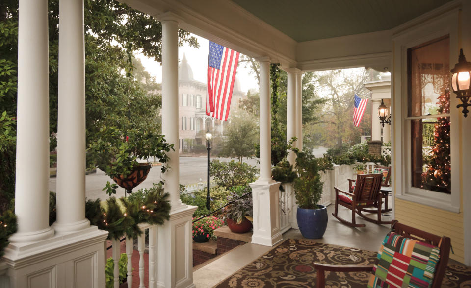 A quaint porch with American flags.