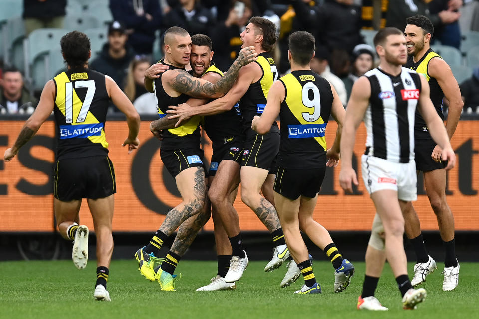 Pictured here, Richmond's Dustin Martin being congratulated by teammates after kicking a goal during against Collingwood.