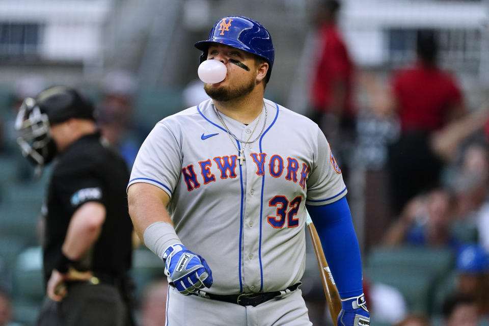 New York Mets' Daniel Vogelbach blows a bubble as he walks back to the dugout after striking out during the second inning of the team's baseball game against the Atlanta Braves on Tuesday, Aug. 16, 2022 in Atlanta. (AP Photo/John Bazemore)