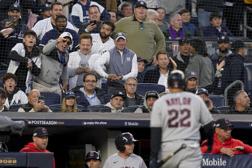 New York Yankees fans shout as Cleveland Guardians Josh Naylor (22) walks back to the dugout after lining out during the sixth inning of Game 5 of an American League Division baseball series against the New York Yankees, Tuesday, Oct. 18, 2022, in New York. (AP Photo/Frank Franklin II)
