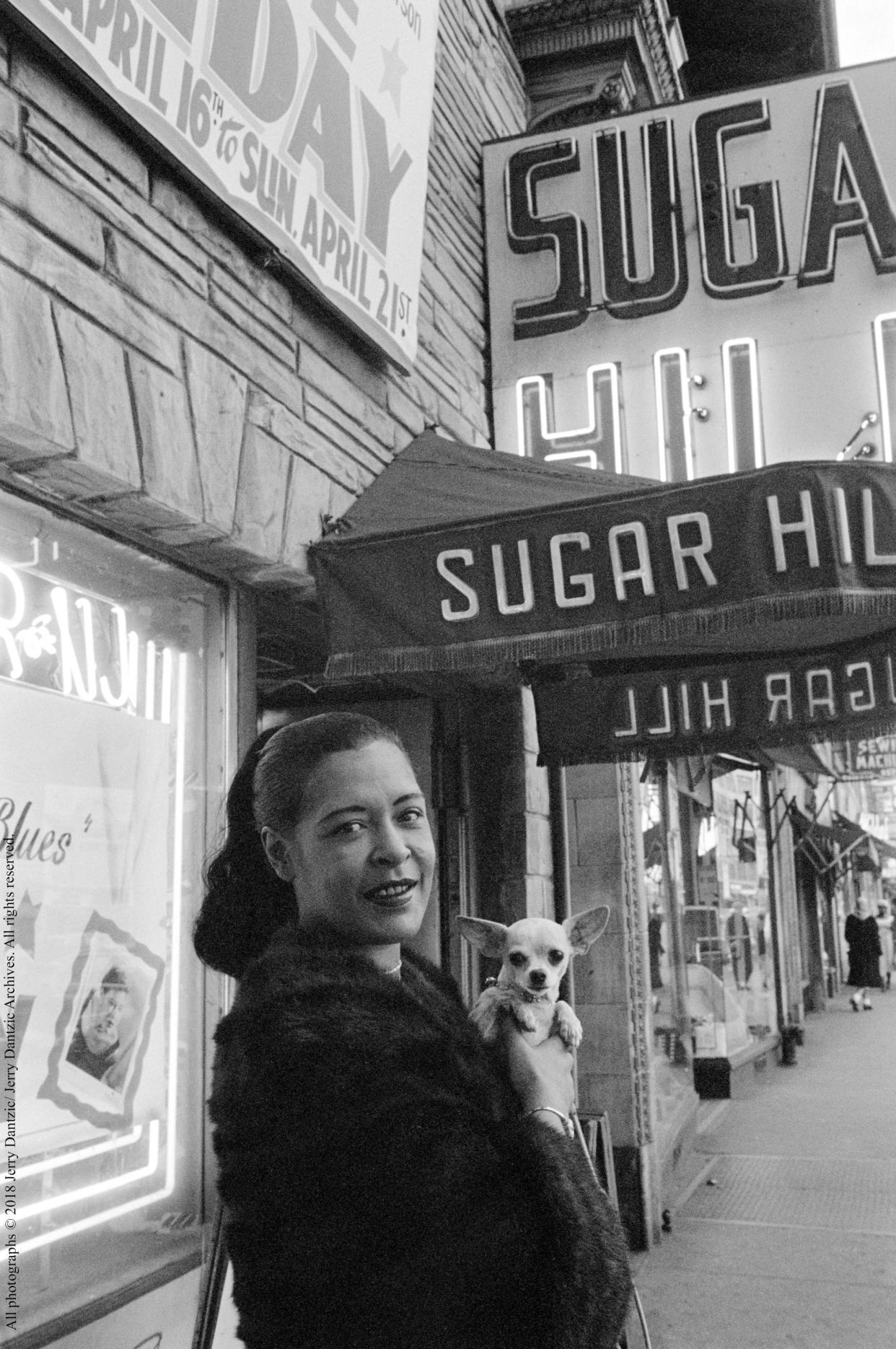 Billie Holiday  holding her pet Chihuahua in front of Sugar Hill,  Newark, New Jersey, April 18, 1957 - Credit: © 201 8 Jerry Dantzic/ Jerry Dantzic Archives