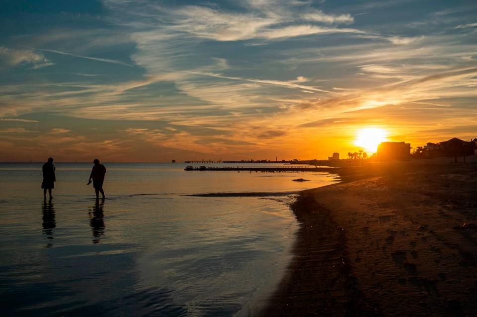 A couple walks in the water at Biloxi Beach in Biloxi on Wednesday, Sept. 22, 2021.