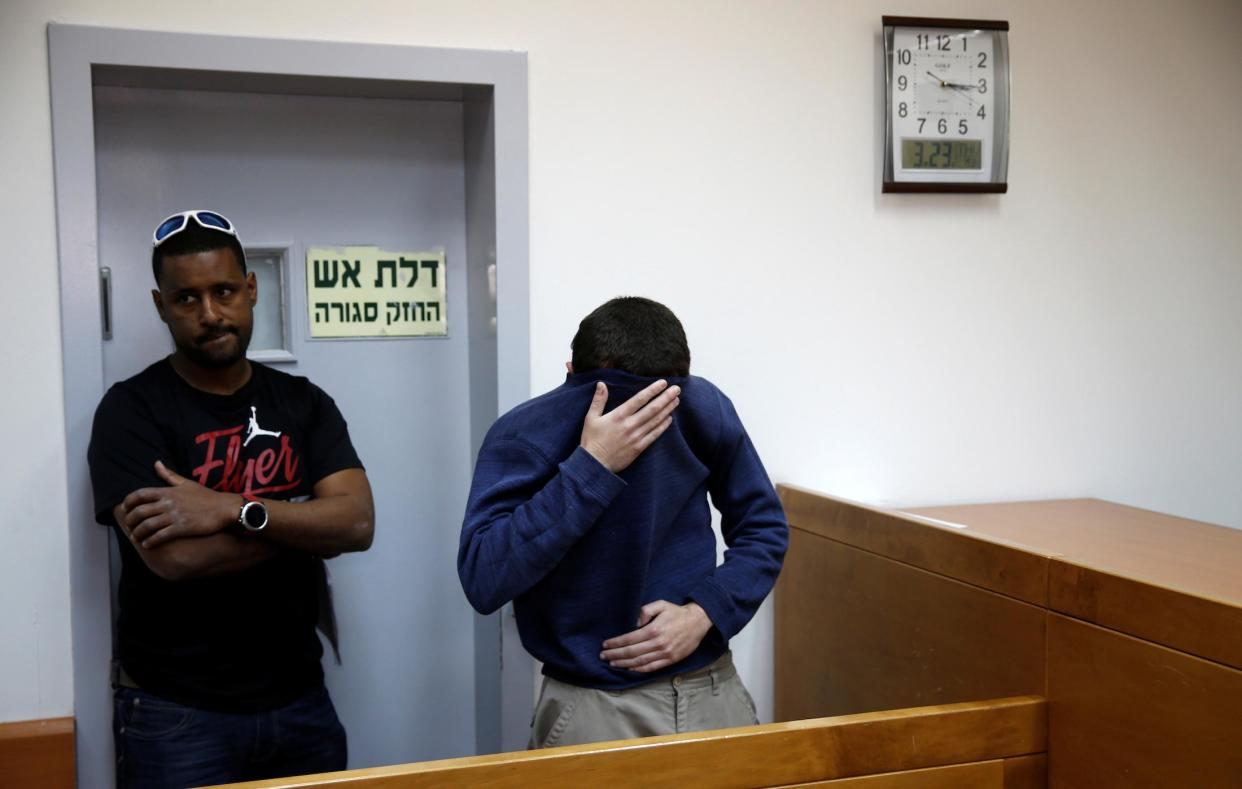 The teenager arrested on suspicion of making bomb threats against Jewish centres (right) attends a hearing in the Israeli city of Rishon LeZion on 23 March: Reuters