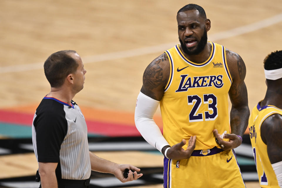 Los Angeles Lakers' LeBron James (23) talks to referee John Goble during the first half of the team's NBA basketball game against the San Antonio Spurs, Friday, Jan. 1, 2021, in San Antonio. (AP Photo/Darren Abate)