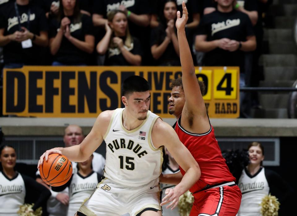 Purdue Boilermakers center Zach Edey (15) is defended by Grace College's Elijah Malone (50) during a men’s basketball exhibition game on Nov. 1, 2023, at Mackey Arena in West Lafayette, Ind.