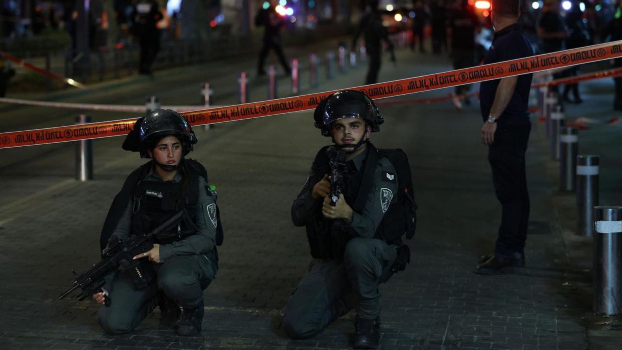 PHOTO: Armed Israeli police officers stand watch near a cordon at the site of a shooting in Tel Aviv, Israel, October 1, 2024. (Abir Sultan/EPA-EFE/Shutterstock)