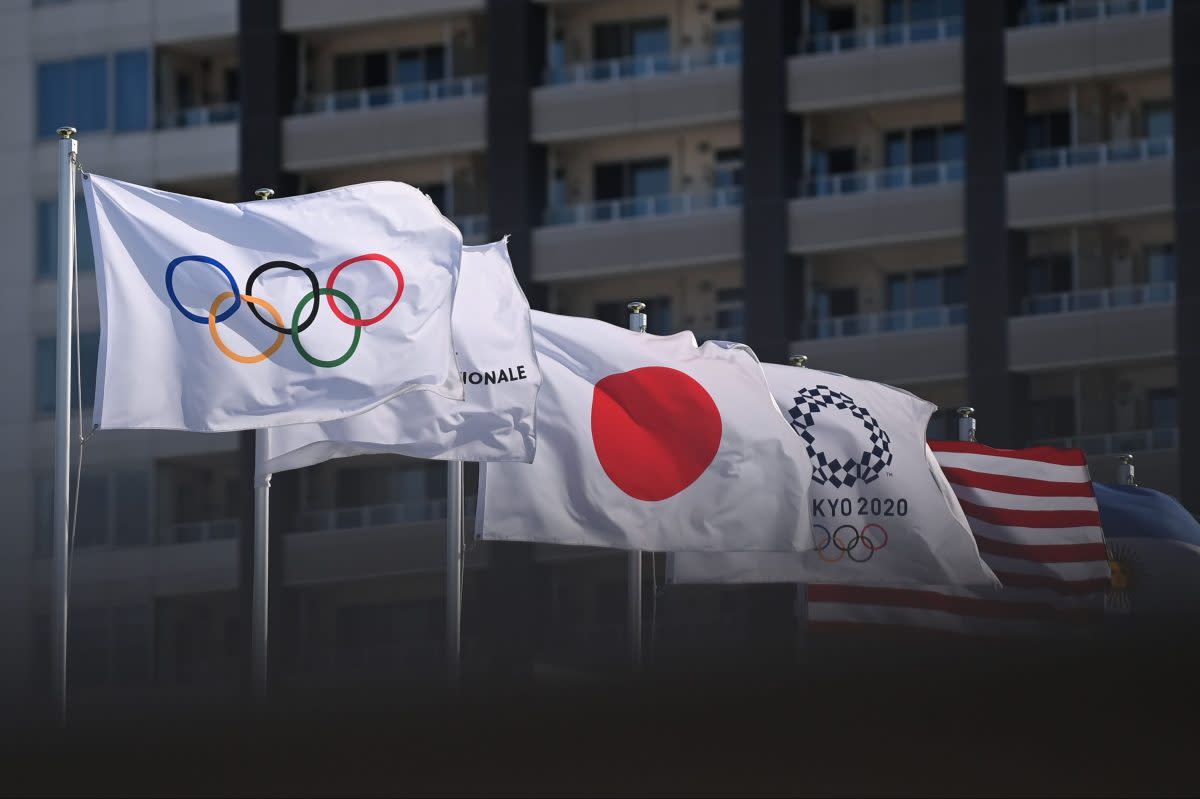 Olympic flags with the Olympic rings and Tokyo Olympics logo, as well as Japanese and American flags, are hoisted on flagpoles