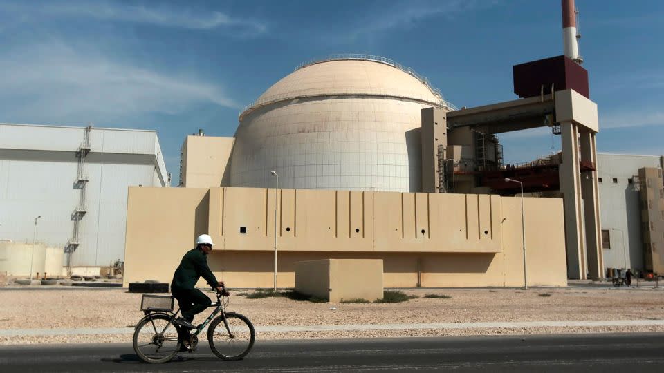 A worker rides past the reactor building of the Bushehr nuclear power plant, just outside the southern city of Bushehr, Iran, in 2010. - Majid Asgaripour/AP