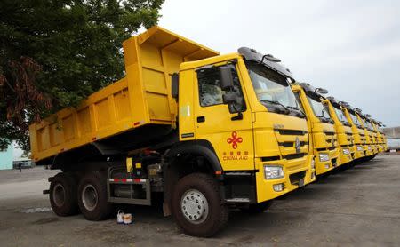 A row of dump trucks donated by China, that will aid in the rehabilitation of the war-torn Marawi city, is seen in the port of Iligan city, southern Philippines October 19, 2017. REUTERS/Romeo Ranoco